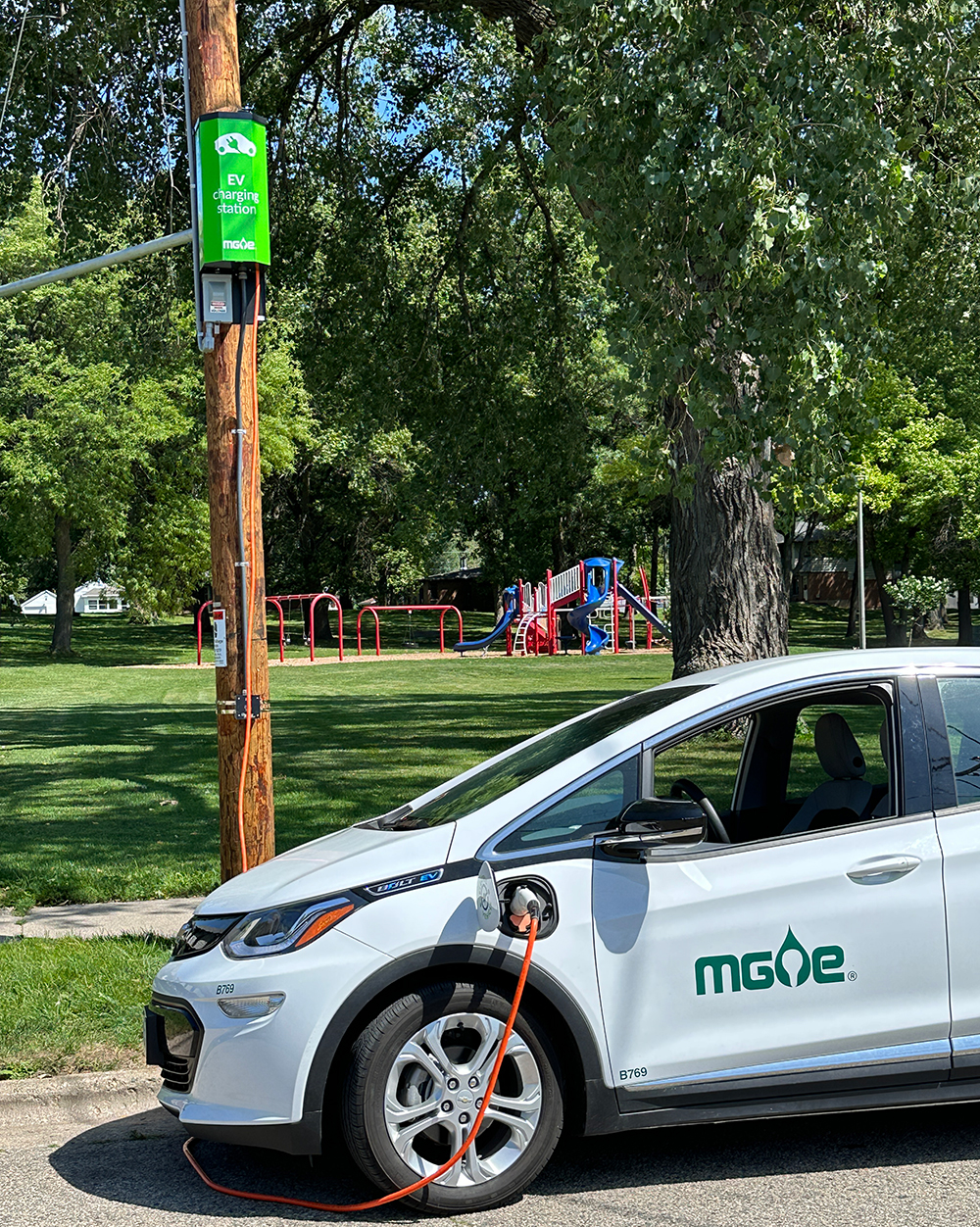 pole-mounted charger plugged into an electric vehicle