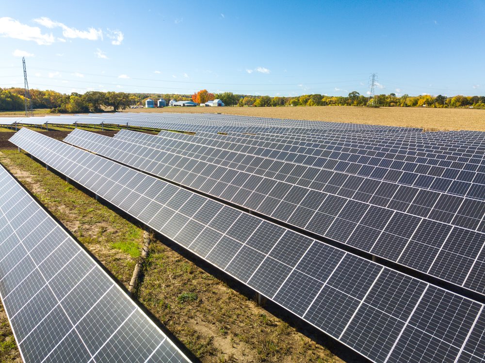 An aerial view of the solar array at Badger Hollow Solar Farm in Iowa County, with clear blue skies along the horizon.